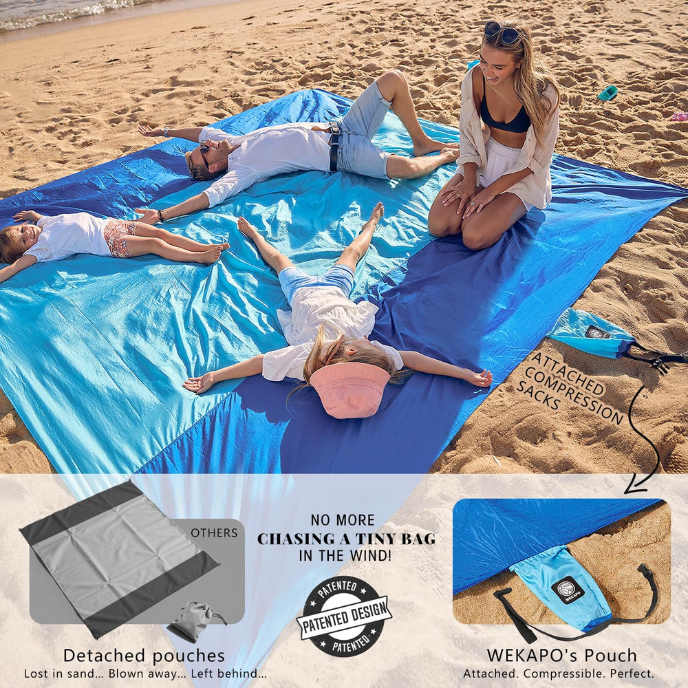 WEKAPO blanket in use on sand with anchor stakes for stable, sand-free seating