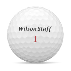 Wilson Staff Zip bola en césped destacando vuelo y beneficio de estabilidad