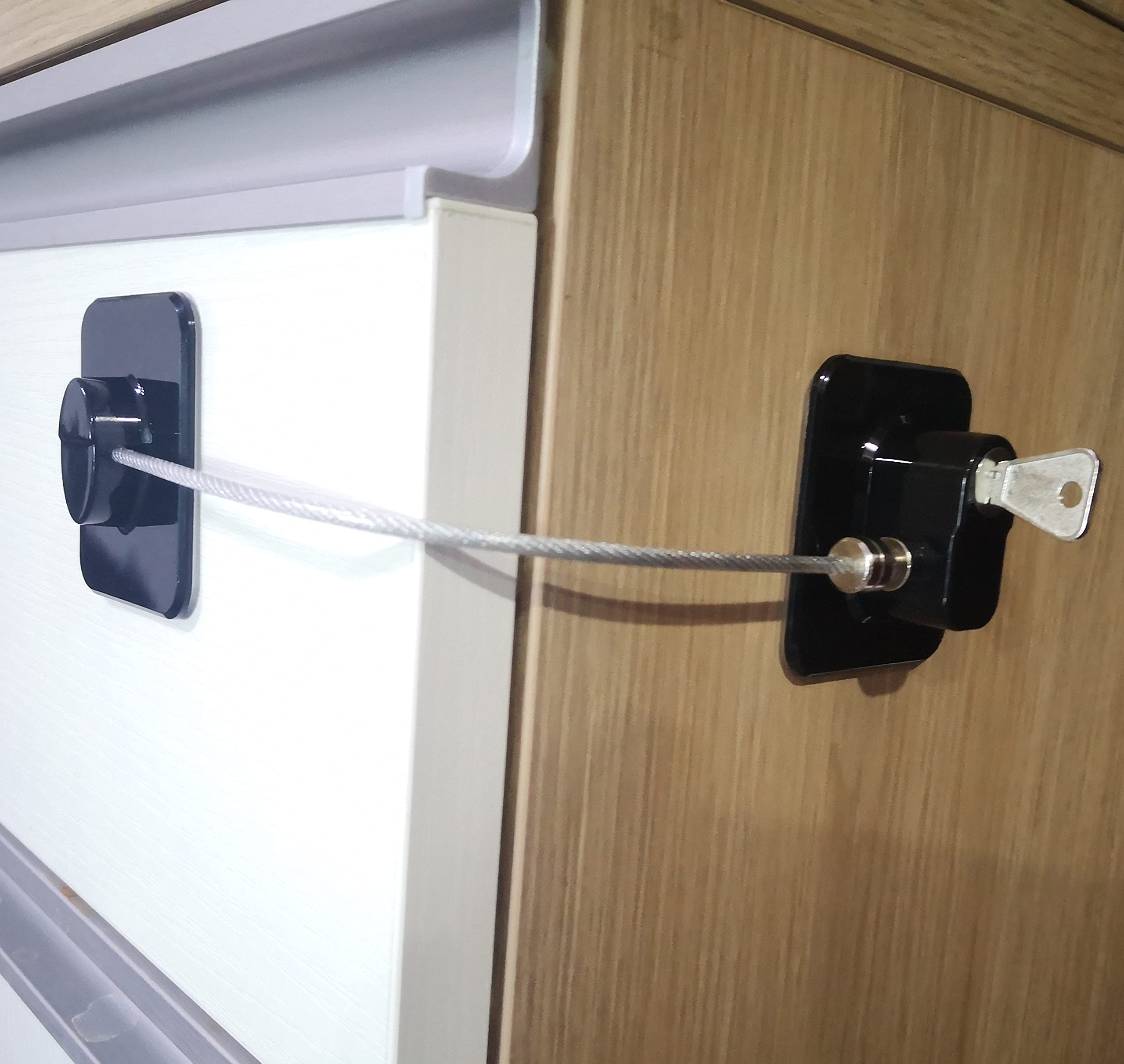 YEYA lock held next to adult hand to show compact size and scale advantage